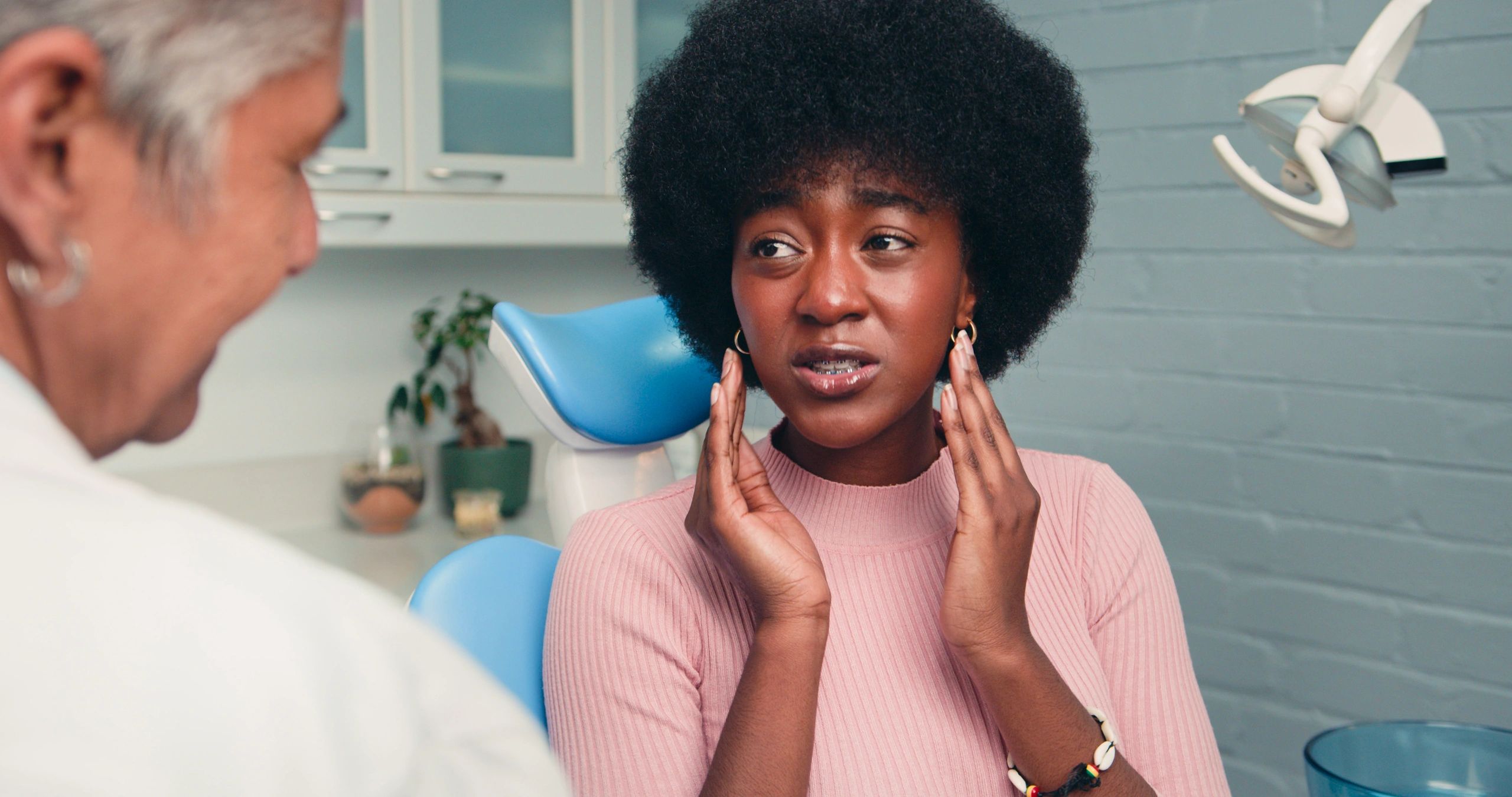 Patient discussing jaw pain symptoms with dentist